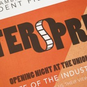 Close-up photograph of the poster for Watersprite 2011, black and white text on an orange background.