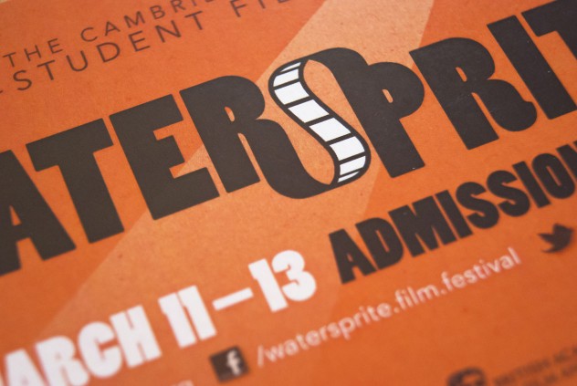 Close-up photograph of the flyer for Watersprite 2011, black and white text on an orange background.